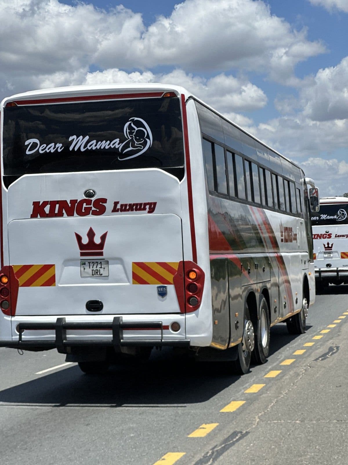 Rear and side view of a Kings Luxury coach on the road