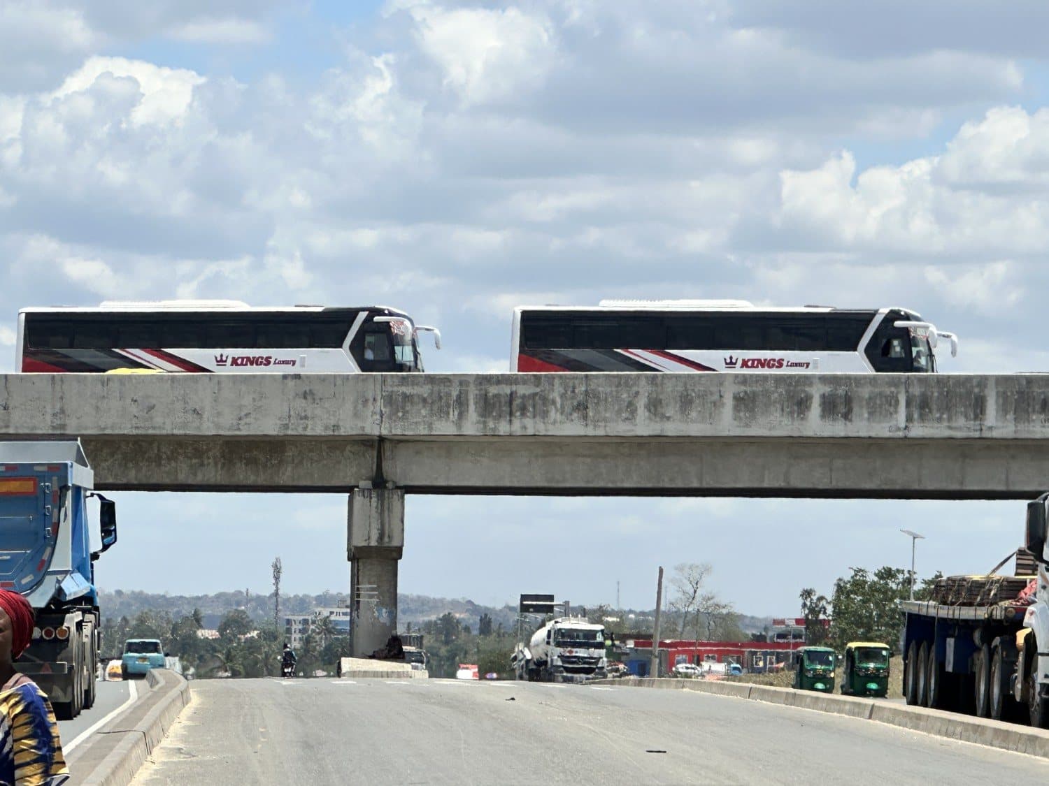 Two Kings Luxury coaches crossing an overpass
